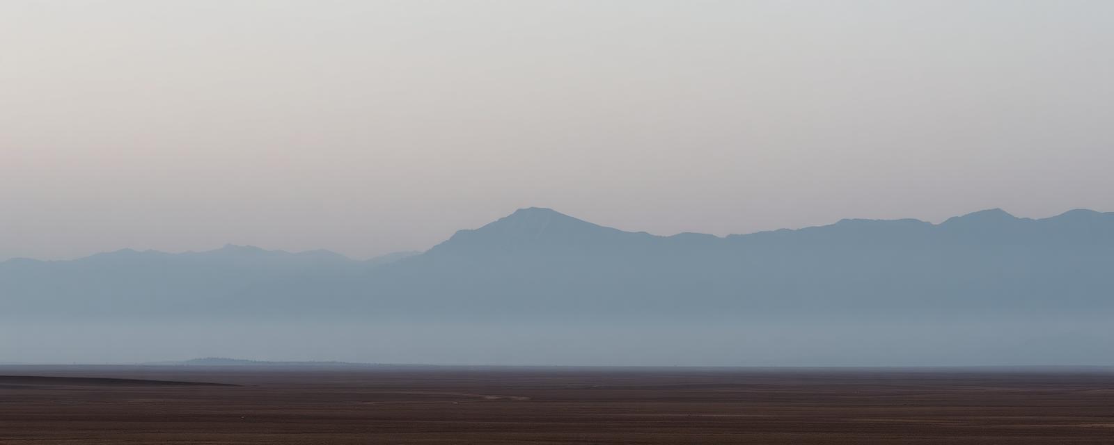Distant mountains in soft morning mist
